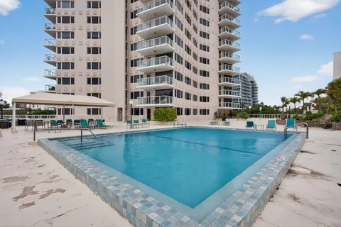 a view of a swimming pool with a lounge chairs