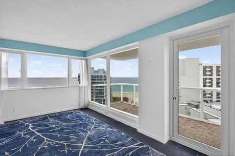 a view of a room with a window and wooden floor