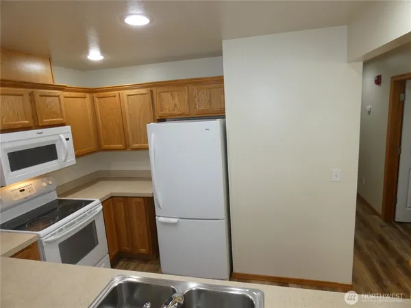 a kitchen with a refrigerator and a sink