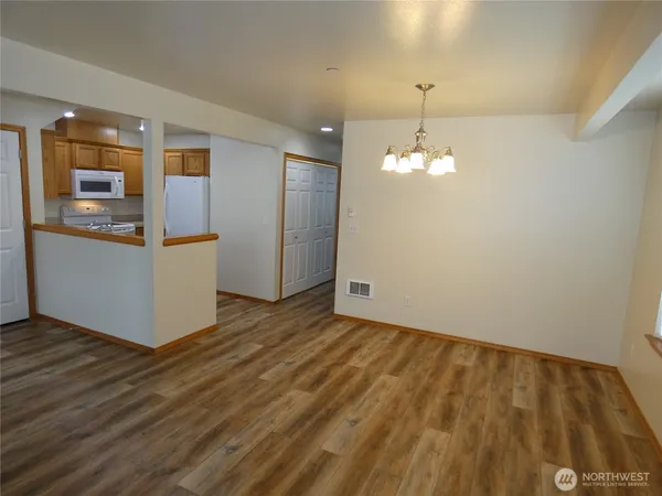 a view of a kitchen with wooden floor and a sink