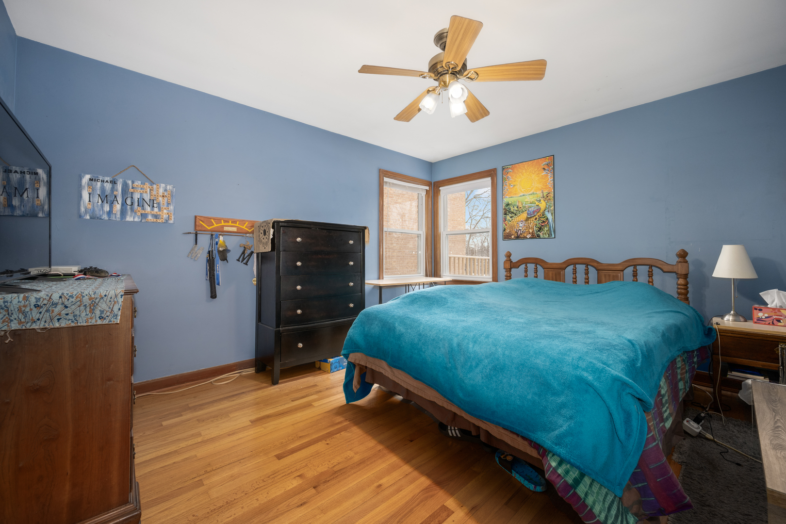 5706 North Mozart Street Chicago, IL 60659 - Photo 14 of 28 a bedroom with a bed and a chandelier