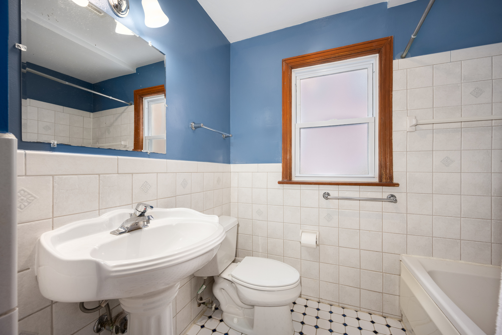 5706 North Mozart Street Chicago, IL 60659 - Photo 15 of 28 a bathroom with a sink a toilet and mirror