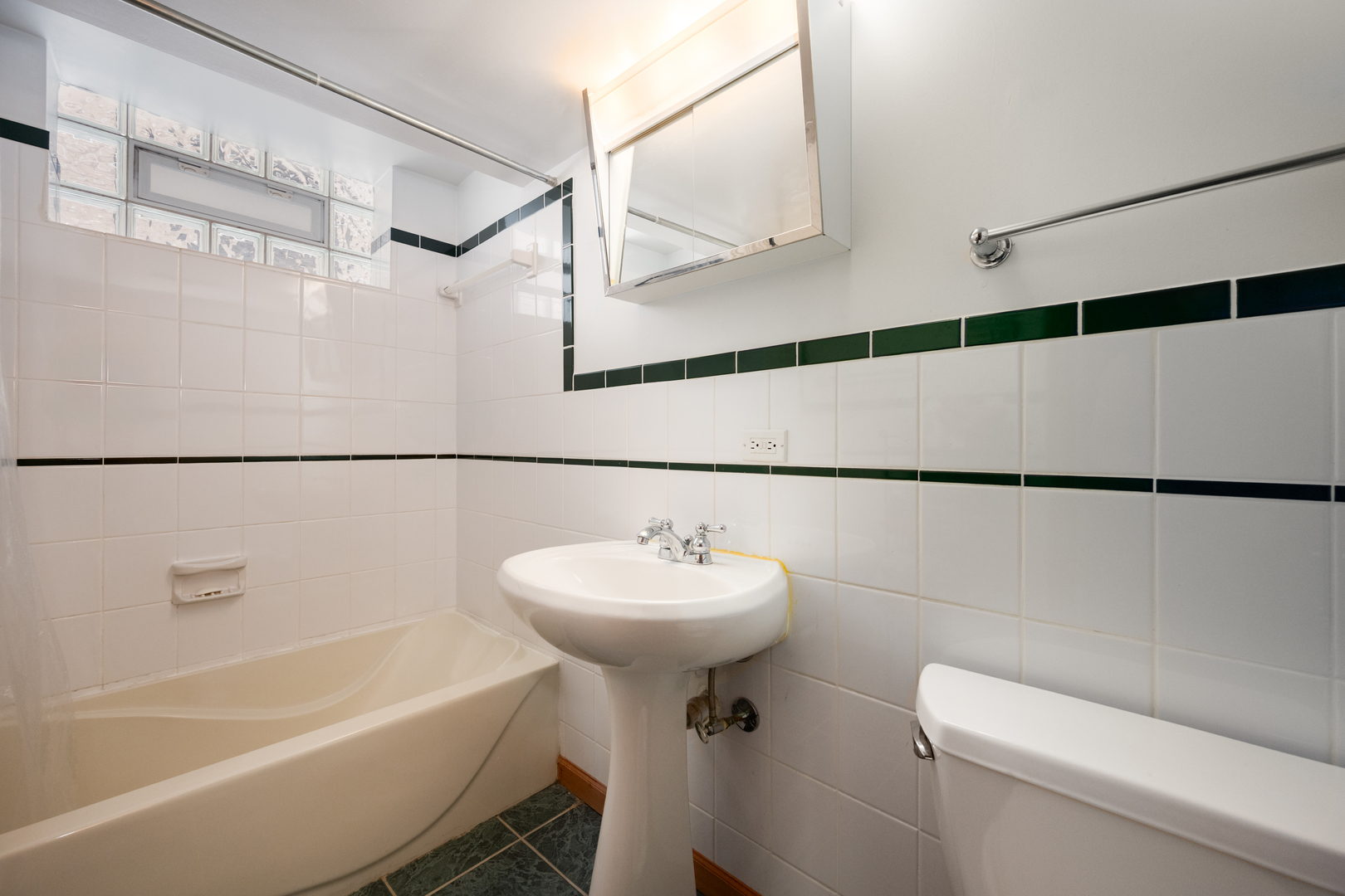 5706 North Mozart Street Chicago, IL 60659 - Photo 19 of 28 a bathroom with a sink a mirror toilet and bathtub