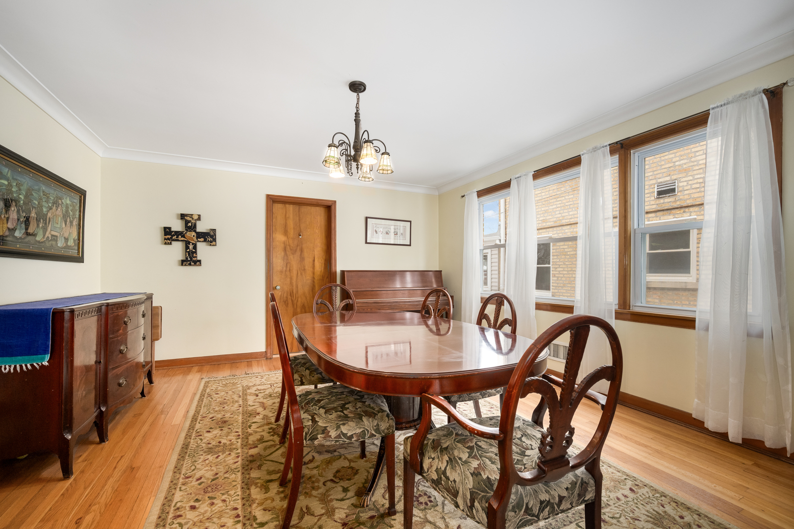 5706 North Mozart Street Chicago, IL 60659 - Photo 5 of 28 a view of a dining room with furniture window and wooden floor
