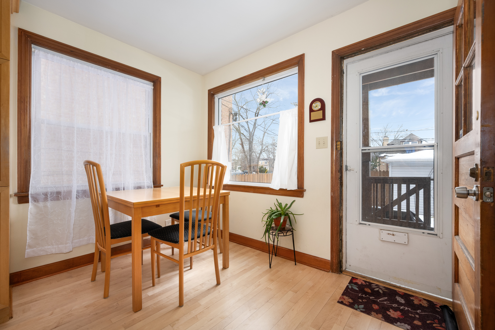 5706 North Mozart Street Chicago, IL 60659 - Photo 8 of 28 a view of a dining room with furniture window and wooden floor