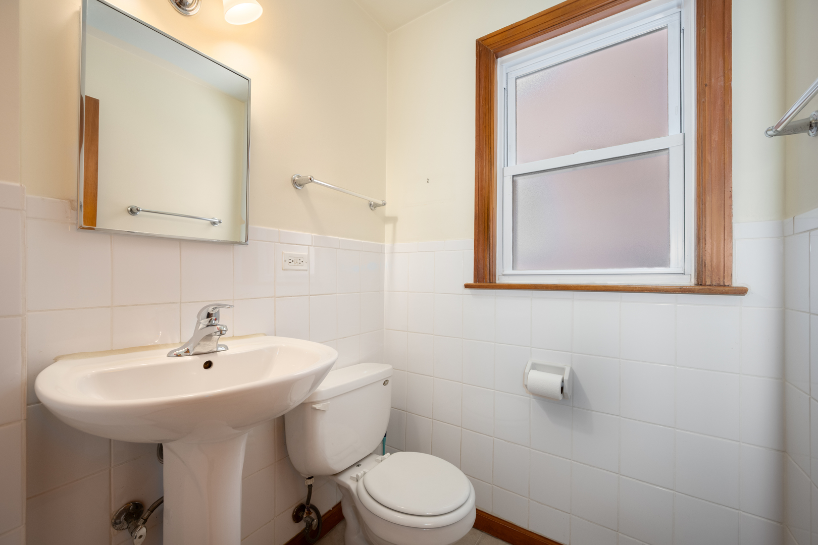 5706 North Mozart Street Chicago, IL 60659 - Photo 9 of 28 a bathroom with a sink a mirror and a toilet