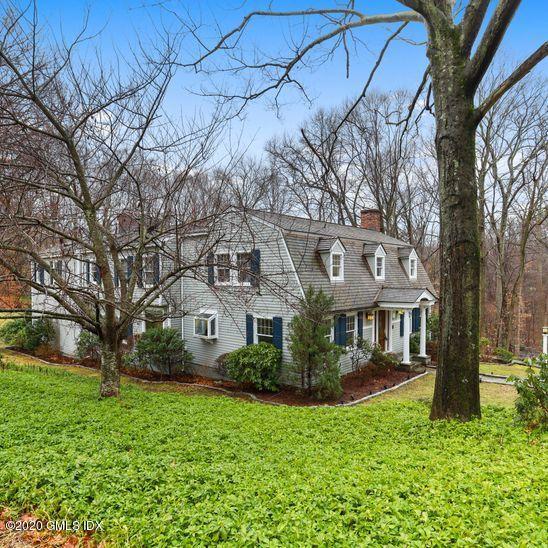 92 North Old Stone Bridge Road Cos Cob, CT 06807 - Photo 1 of 38 a front view of a house with garden