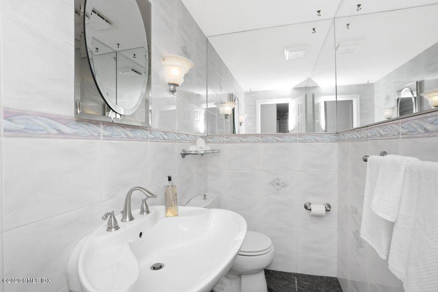 92 North Old Stone Bridge Road Cos Cob, CT 06807 - Photo 13 of 38 a bathroom with a sink a toilet and a mirror