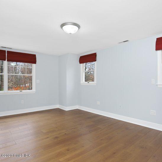 92 North Old Stone Bridge Road Cos Cob, CT 06807 - Photo 20 of 38 a view of an empty room with wooden floor and a window