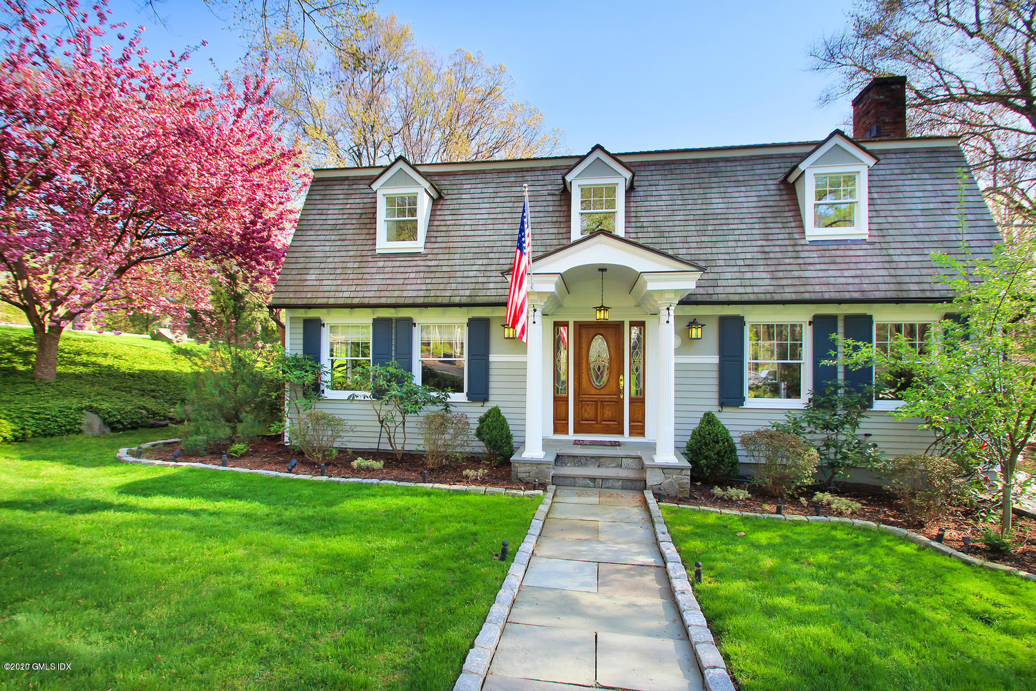 92 North Old Stone Bridge Road Cos Cob, CT 06807 - Photo 2 of 38 a front view of a house with a yard and potted plants