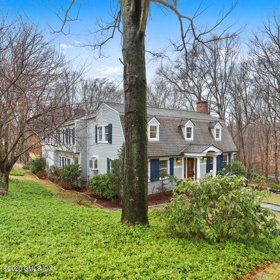 92 North Old Stone Bridge Road Cos Cob, CT 06807 - Photo 35 of 38 a view of a white house next to a yard with big trees