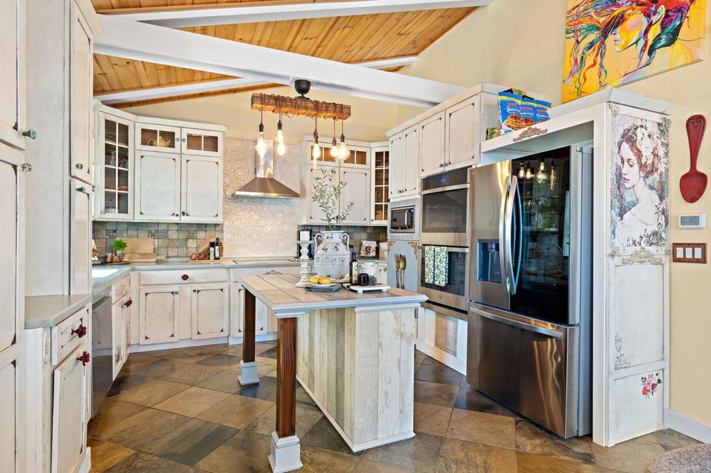 2042 Pheasant Run Road Fallbrook, CA 92028 - Photo 16 of 75 a kitchen with stainless steel appliances granite countertop a stove and a refrigerator