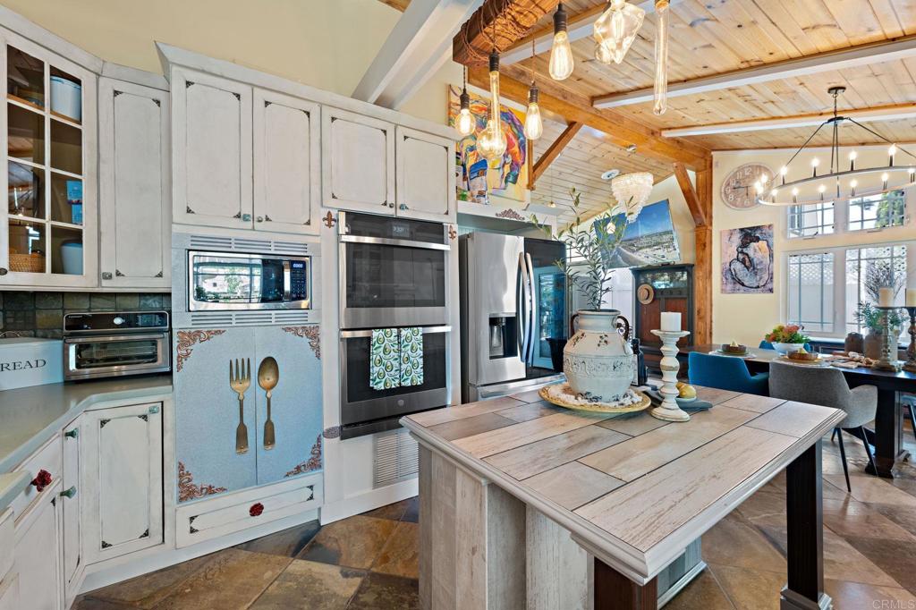 2042 Pheasant Run Road Fallbrook, CA 92028 - Photo 19 of 75 a view of a kitchen with kitchen island a table and chairs in it
