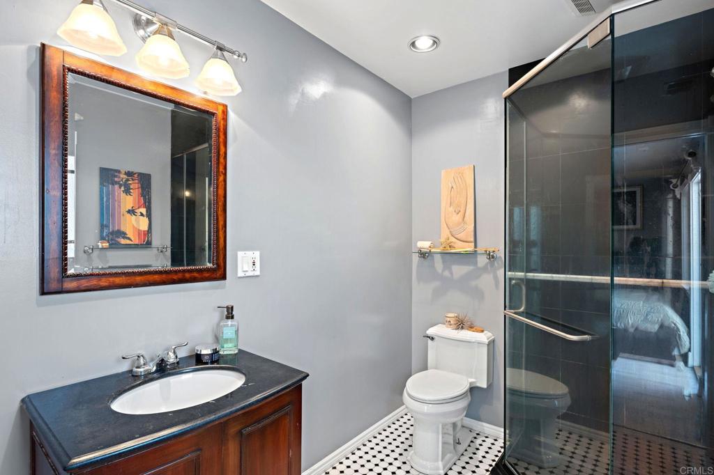 2042 Pheasant Run Road Fallbrook, CA 92028 - Photo 41 of 75 a bathroom with a toilet sink and mirror