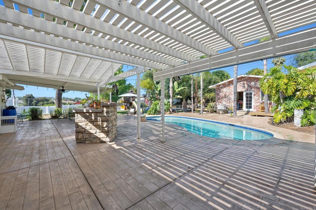 2042 Pheasant Run Road Fallbrook, CA 92028 - Photo 45 of 75 a view of a patio with table and chairs potted plants and floor to ceiling window