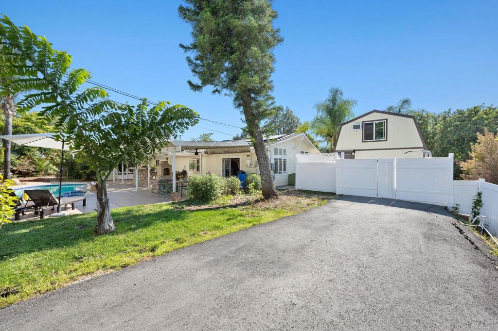 2042 Pheasant Run Road Fallbrook, CA 92028 - Photo 50 of 75 a front view of a house with a garden and trees