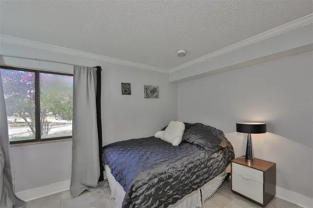 a bedroom with a bed and a lamp