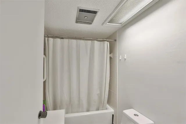 a bathroom with a shower curtain and a sink