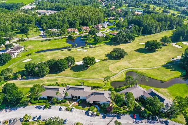 an aerial view of residential houses with outdoor space and street view