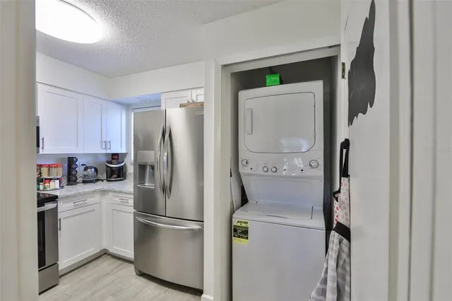 a white refrigerator freezer sitting in a kitchen