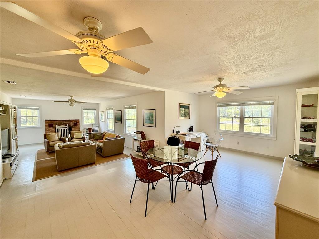 7390 South Mc Alpin Road McAlpin, FL 32062 - Photo 4 of 53 a view of a dining room with furniture and wooden floor