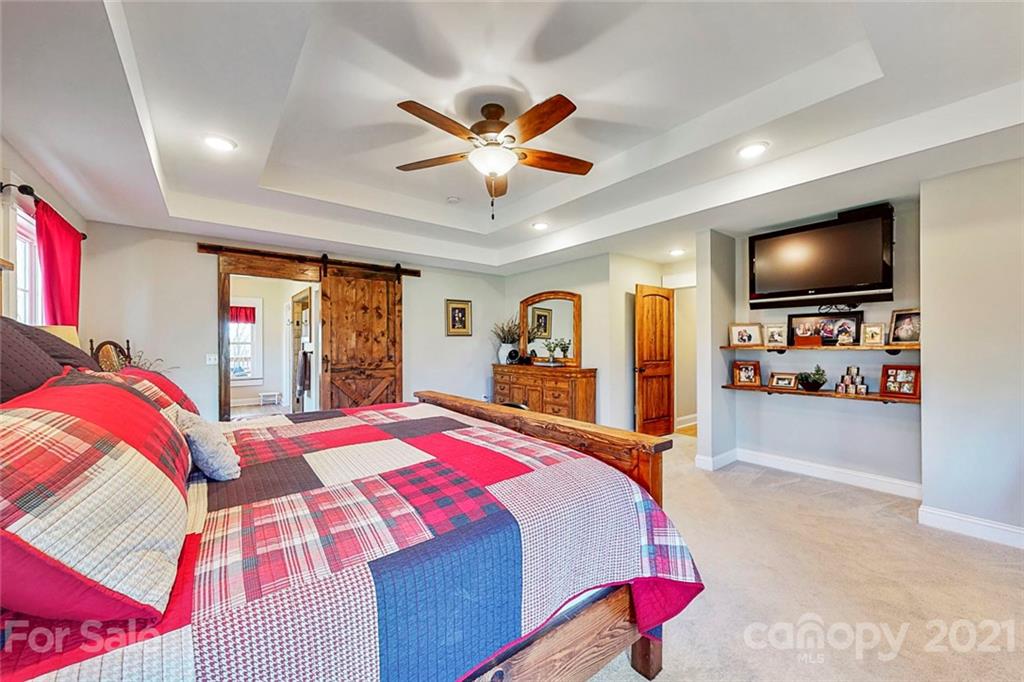 7555 Stokes Ferry Road Salisbury, NC 28146 - Photo 20 of 48 a bedroom with a bed and a flat screen tv