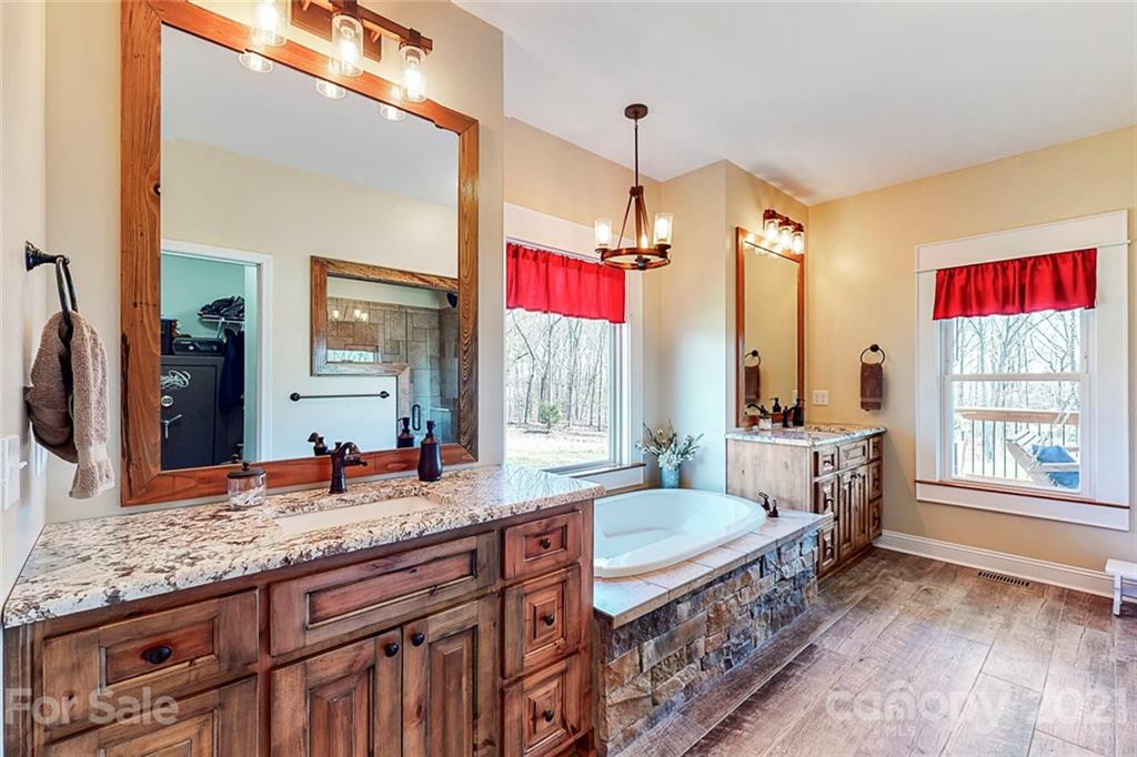 7555 Stokes Ferry Road Salisbury, NC 28146 - Photo 22 of 48 a spacious bathroom with a granite countertop double vanity sink a mirror and a bathtub