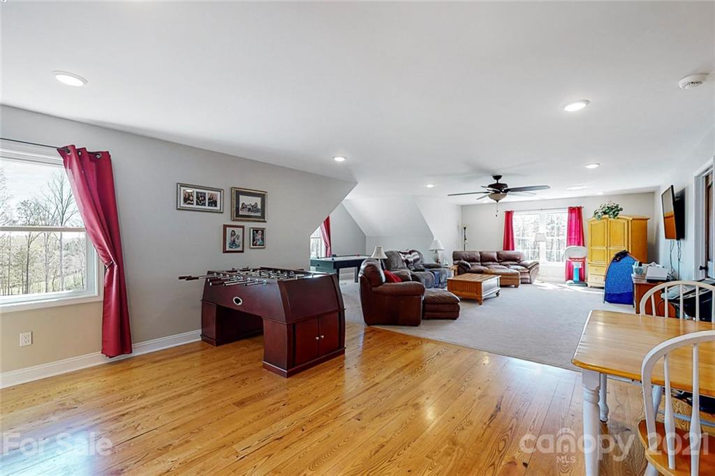 7555 Stokes Ferry Road Salisbury, NC 28146 - Photo 27 of 48 a living room with furniture or couch and a wooden floor