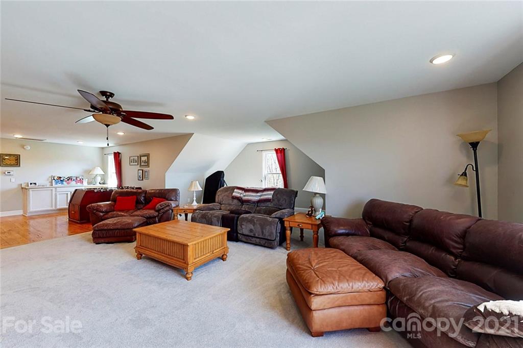 7555 Stokes Ferry Road Salisbury, NC 28146 - Photo 30 of 48 a living room with furniture and a ceiling fan