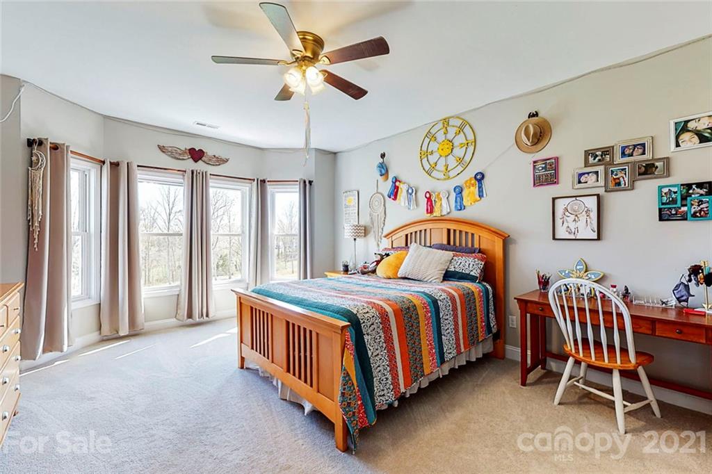 7555 Stokes Ferry Road Salisbury, NC 28146 - Photo 31 of 48 a bedroom with a bed and a table in it