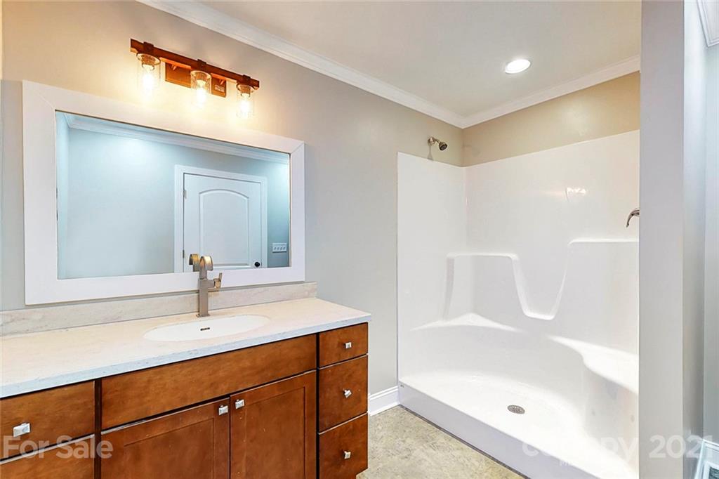 7555 Stokes Ferry Road Salisbury, NC 28146 - Photo 38 of 48 a bathroom with a bathtub shower sink vanity and mirror