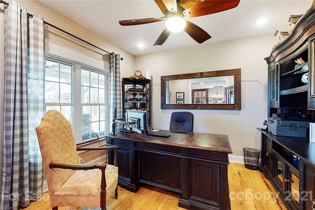 7555 Stokes Ferry Road Salisbury, NC 28146 - Photo 6 of 48 a work room with furniture a flat screen tv and a window