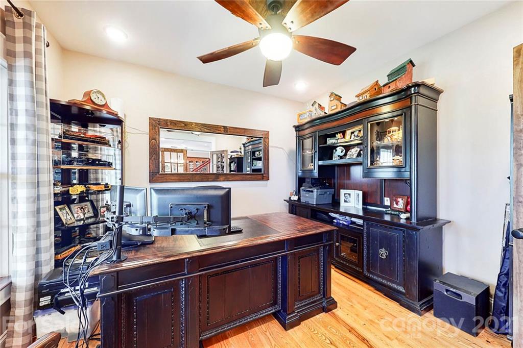 7555 Stokes Ferry Road Salisbury, NC 28146 - Photo 7 of 48 a kitchen with stainless steel appliances granite countertop a sink dishwasher stove and a dining table with wooden floor
