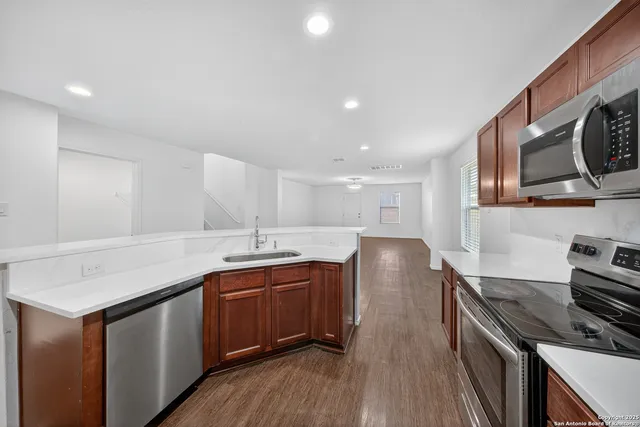 a kitchen with a stove sink and cabinets