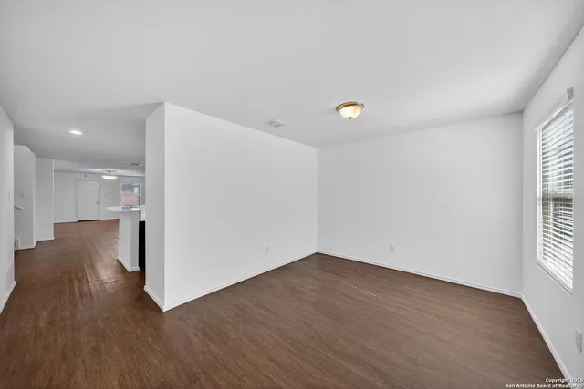 a view of a room with wooden floor and windows
