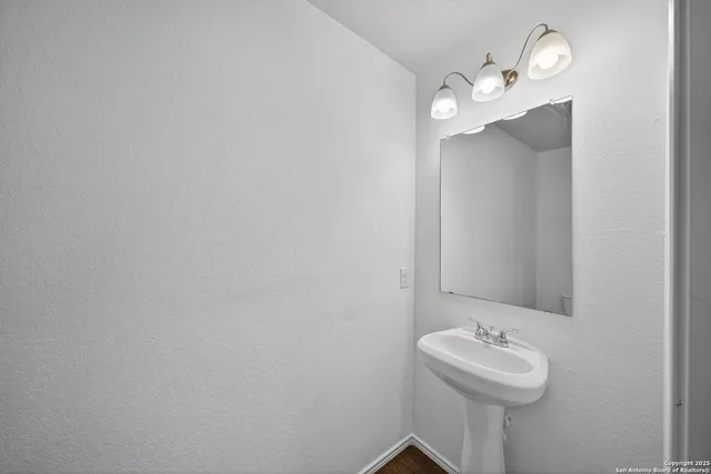 a bathroom with a sink and mirror