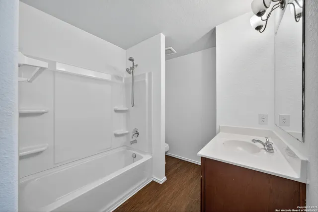 a bathroom with a sink a mirror and a bathtub