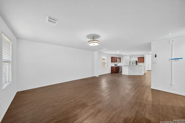 a view of a livingroom with wooden floor and window