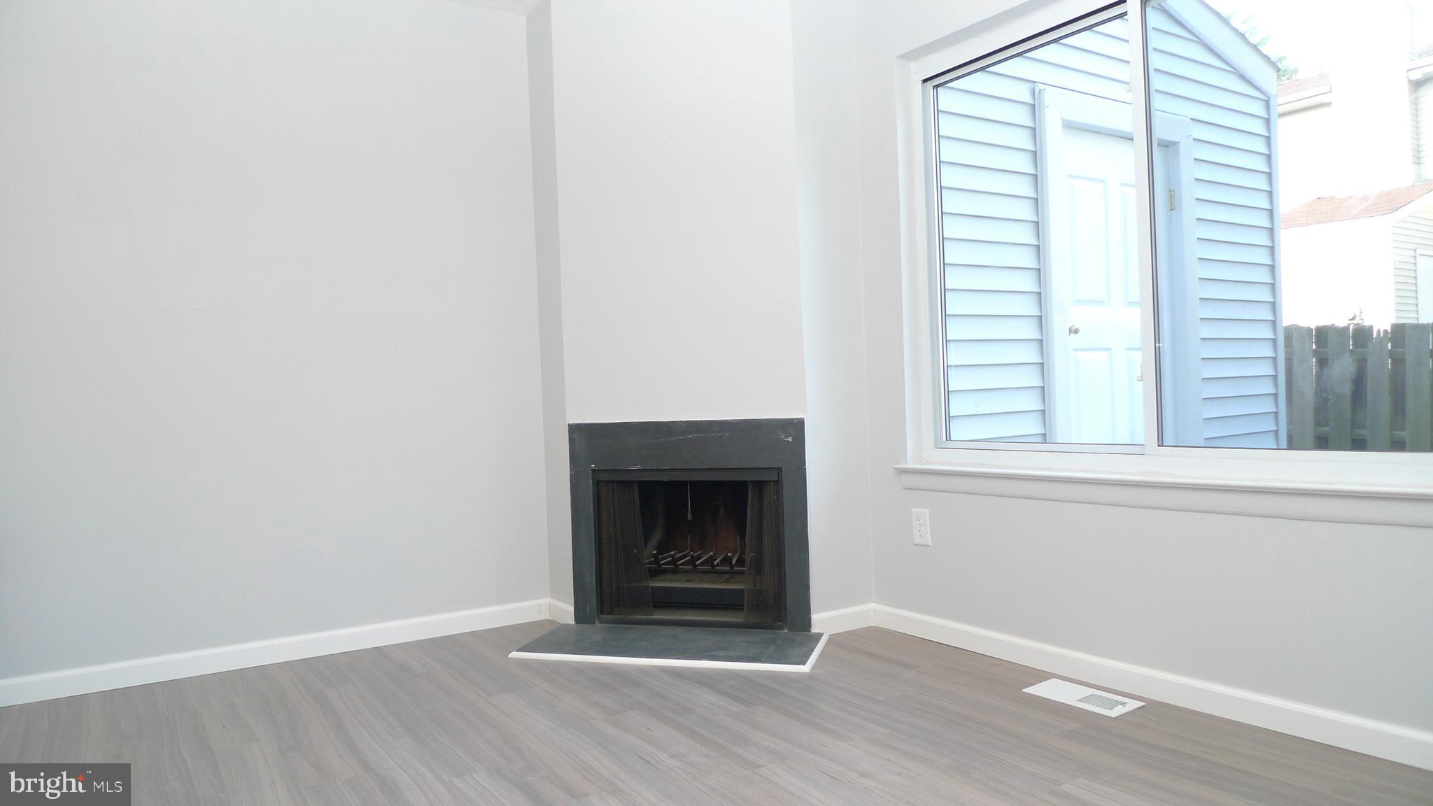 129 Briar Court Marlton, NJ 08053 - Photo 4 of 10 a view of an empty room with wooden floor and a window