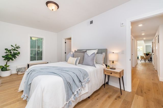 a bedroom with a bed and a potted plant