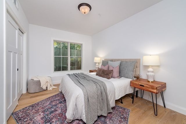 a bedroom with a bed and a lamp