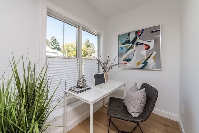 a view of a workspace with furniture and a potted plant