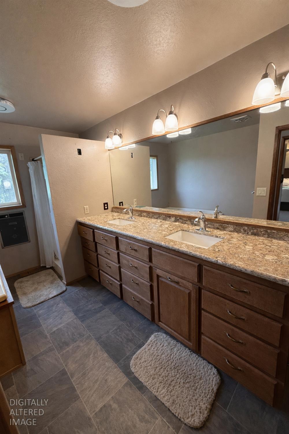 7300 Highway 193 Georgetown, CA 95634 - Photo 14 of 16 a spacious bathroom with a granite countertop sink and a mirror