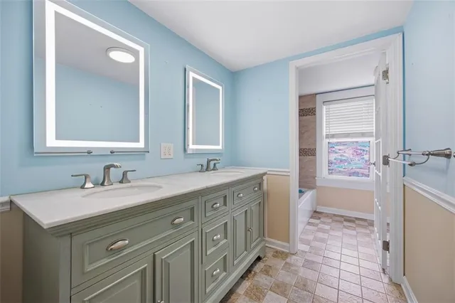 a bathroom with a sink a vanity and a mirror