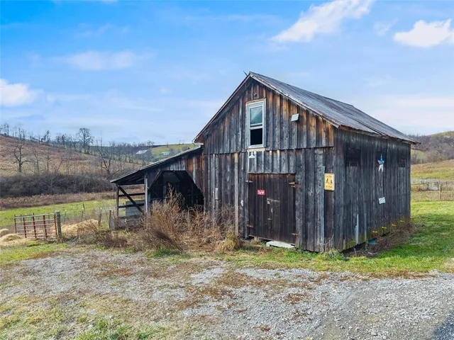 a backyard of a house with barbeque oven
