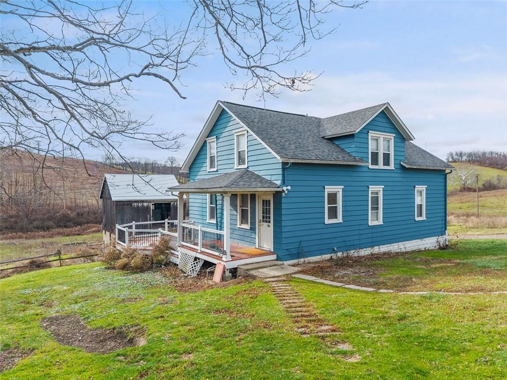 26 Covered Bridge Road Burgettstown, PA 15021 - Photo 3 of 49 a front view of a house with a yard table and chairs