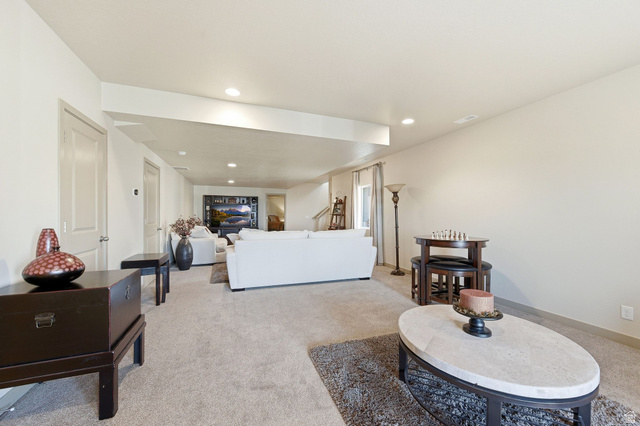 987 East Deer Arch Lane Draper, UT 84020 - Photo 34 of 46 Large basement living room featuring carpet floors, a textured ceiling, and recessed lighting