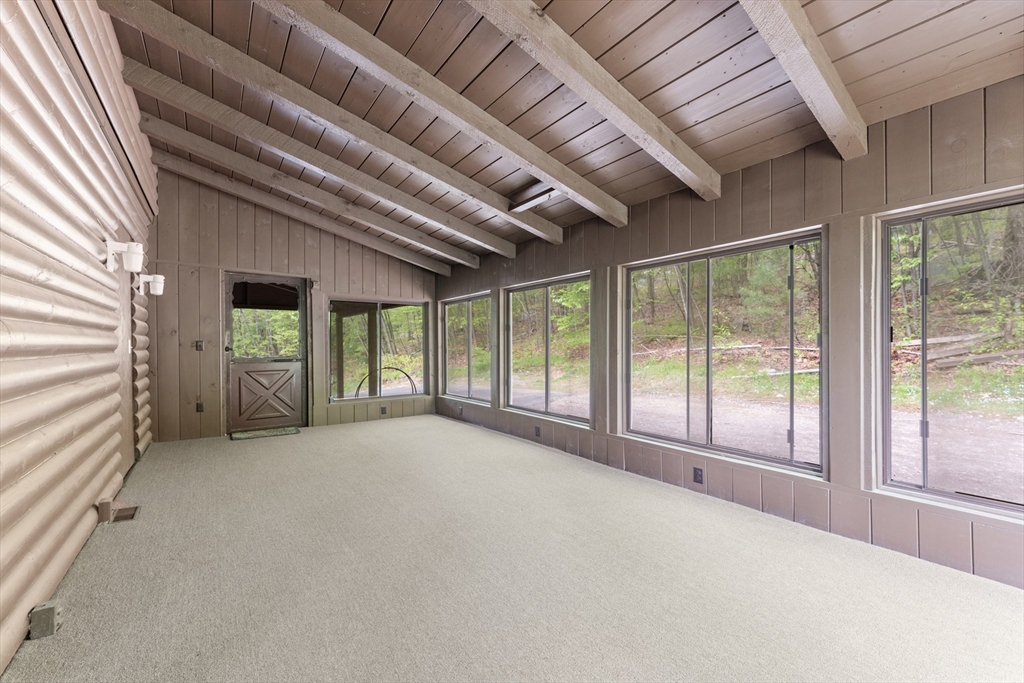 470 Mountain Road Wilbraham, MA 01095 - Photo 11 of 42 a view of an empty room with a fireplace and a large window