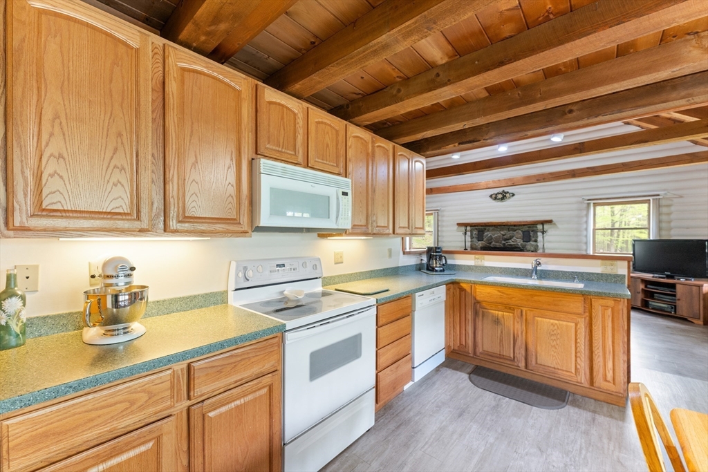 470 Mountain Road Wilbraham, MA 01095 - Photo 17 of 42 a kitchen with stainless steel appliances granite countertop a sink a stove cabinets counter space and a window