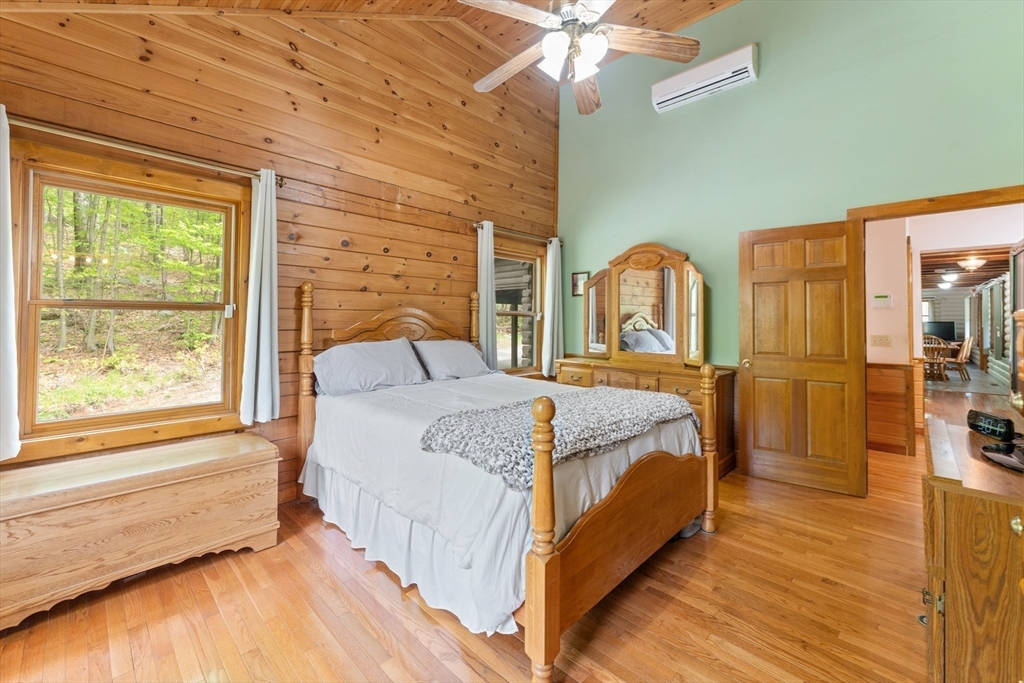 470 Mountain Road Wilbraham, MA 01095 - Photo 26 of 42 a bedroom with a bed a mirror on dresser and a large window